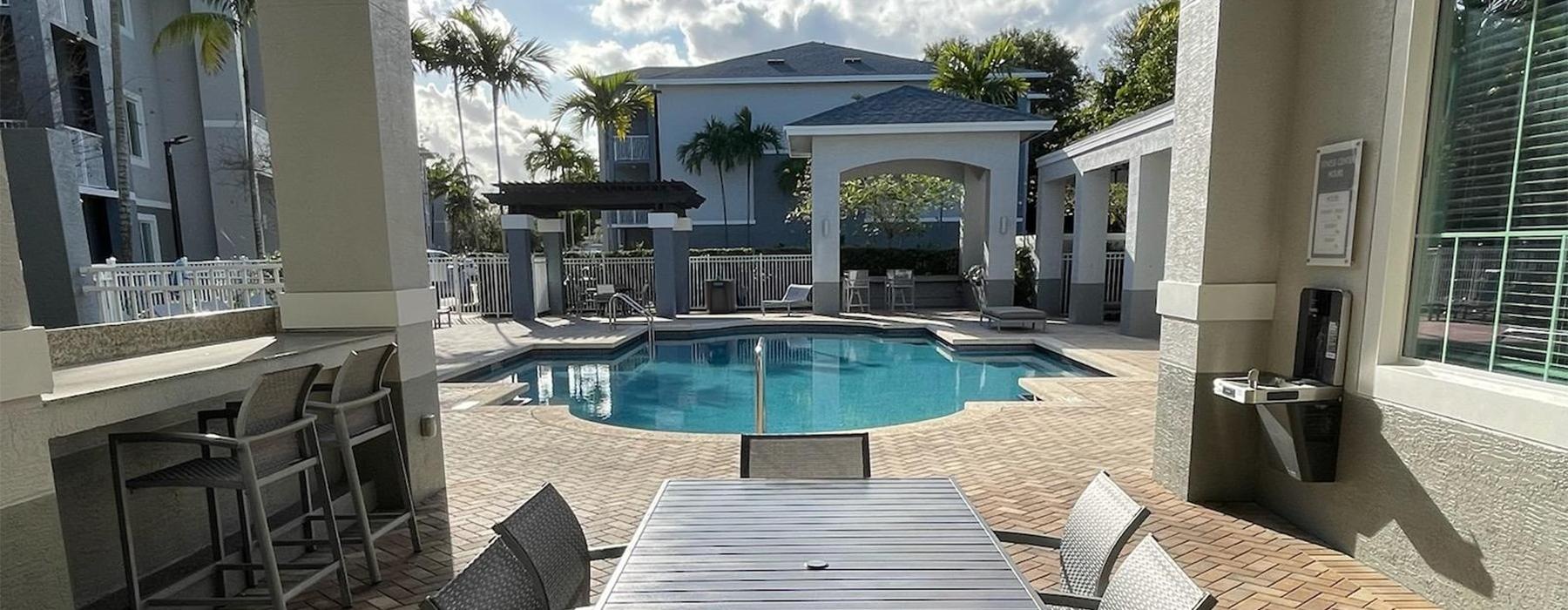 a pool and chairs on a deck
