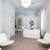 room with white chairs and tv