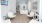 a room with white walls and a wood floor with a white table and chairs and a white table